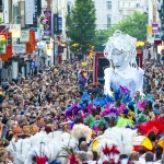 brazilica festival with crowds and a giant white puppet