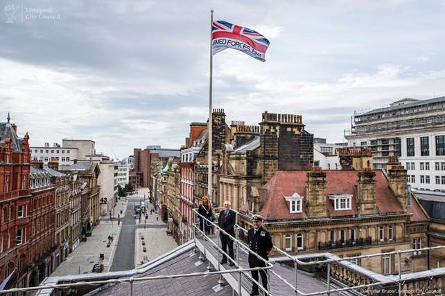 Armed Forces Day flag is raised on the roof of Liveprool Town Hall against a grey sky