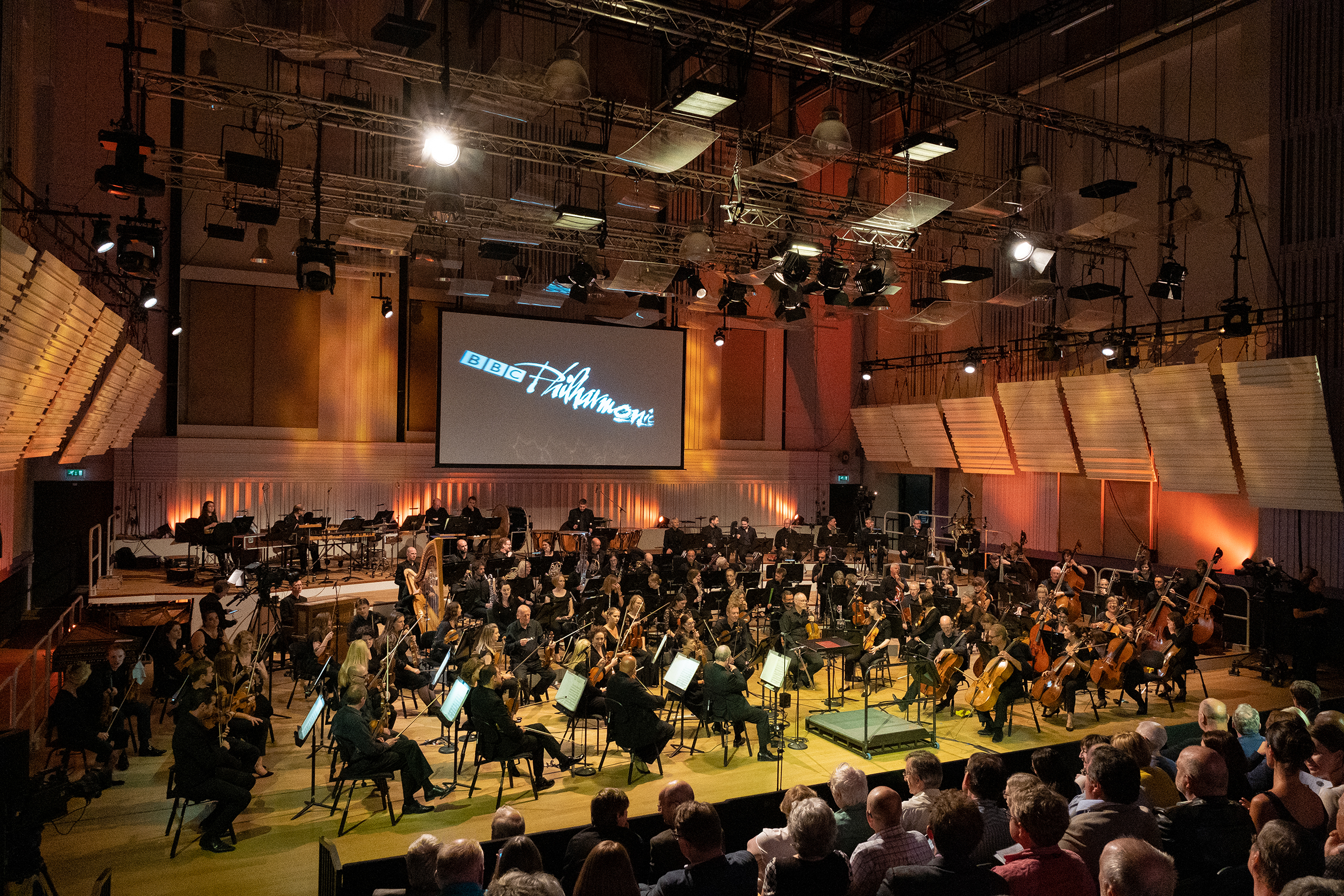 BBC Philharmonic perfoming indoors with red lighting