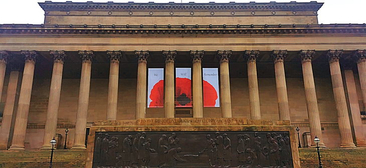 Front of st georges hall with the cenotaph in front of the building, and the three remembrance banners hanging from the columns