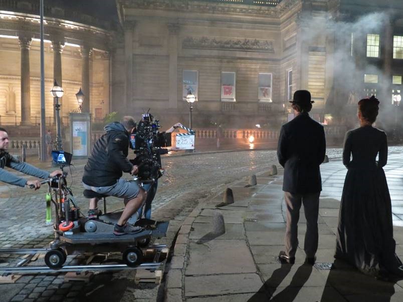 filming outside st georges hall with two people in period victorian costume next two 21st century film crew the hollywood of the north