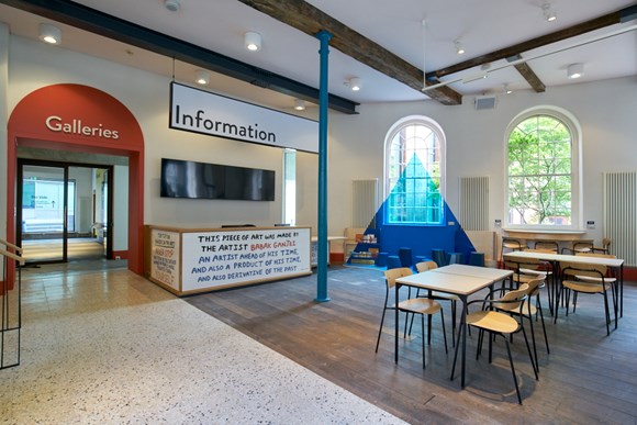 inside bluecoat hub with chairs and tables and artwork installation