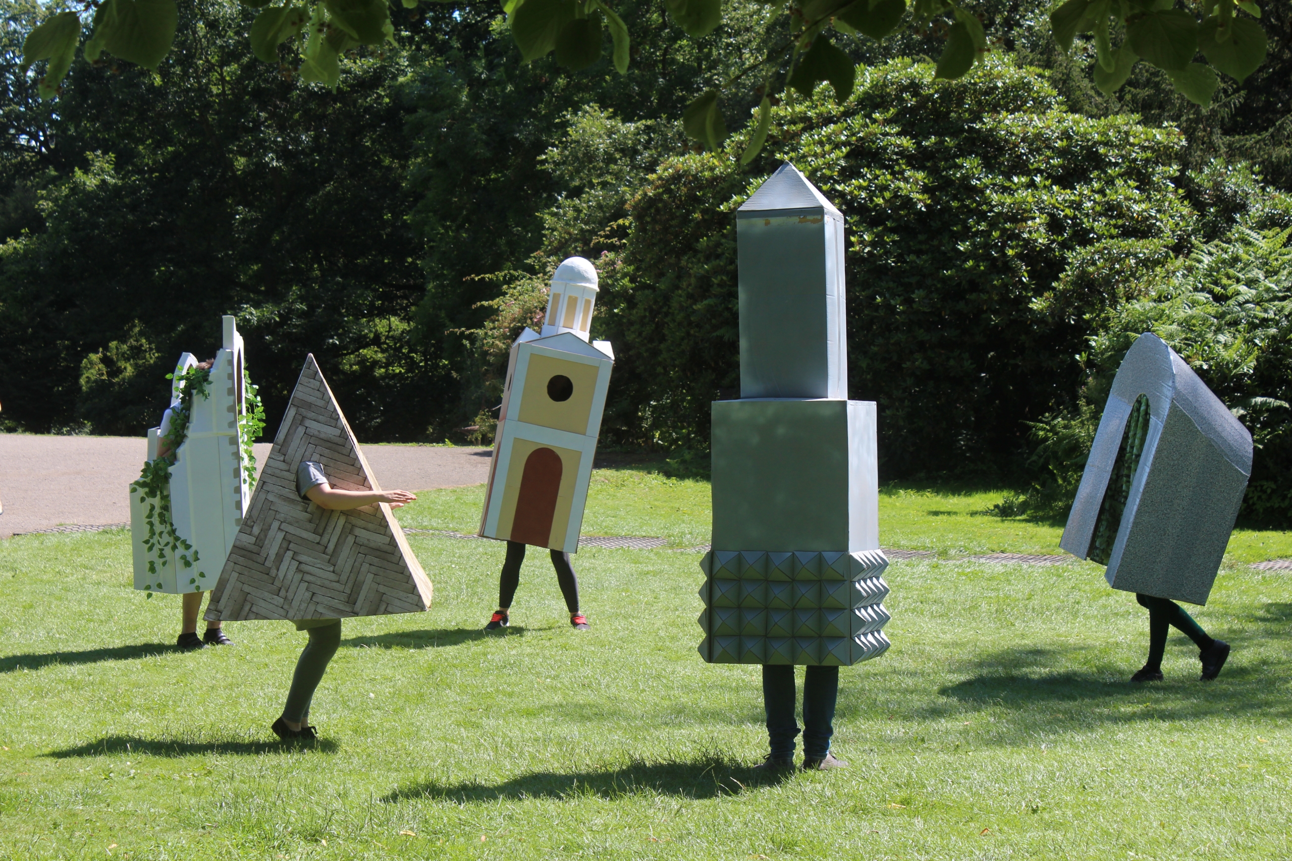 a parade of architectural commas performing in an outdoor park called flatland