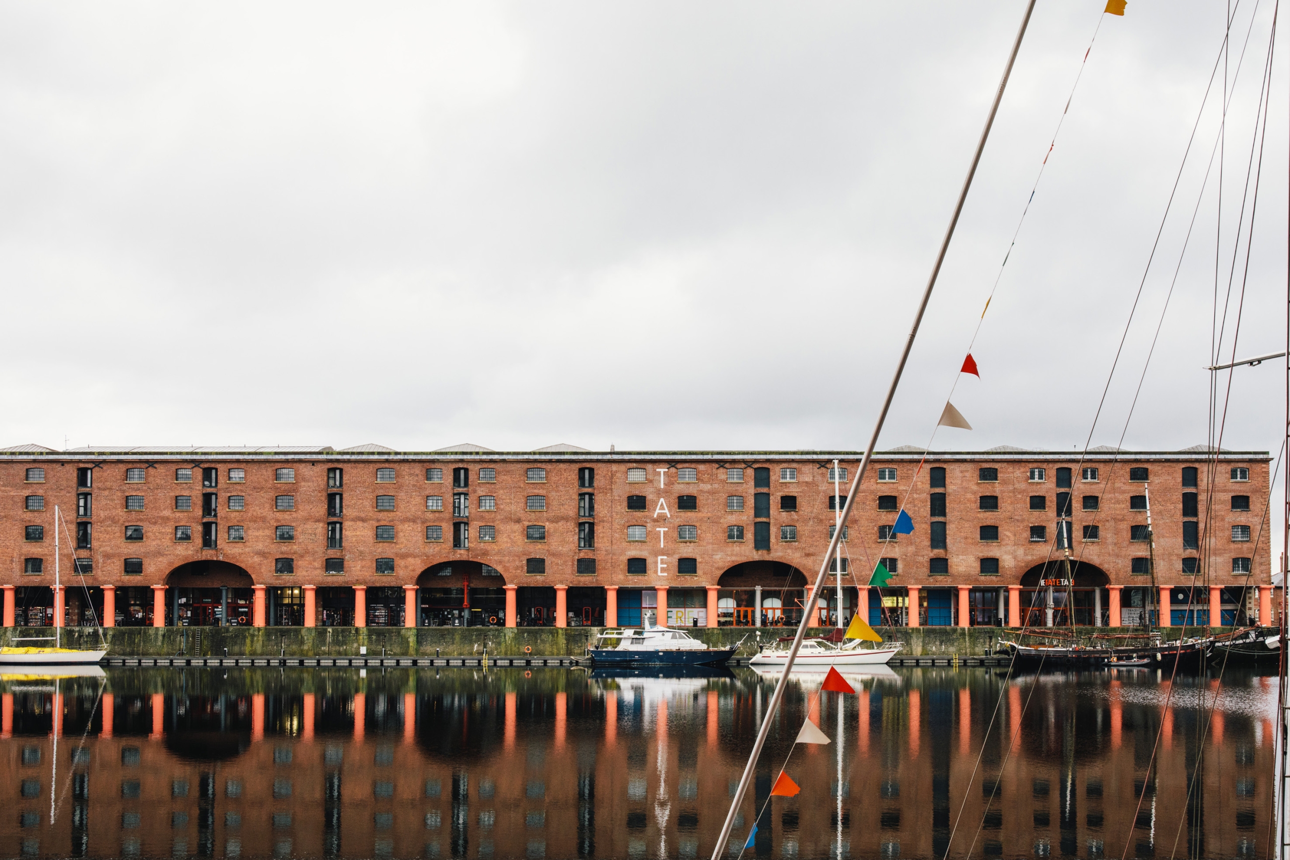 Tate Liverpool viewed from opposite side of alvert dock against a grey sky
