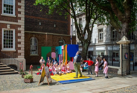 bluecoat outdoor sculpture with children and an performer