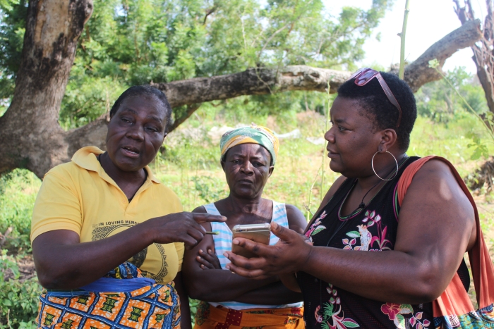 three black ladies in africa holding a bowl -one of whom is betty the cook