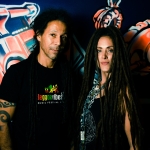 male and female artists stoof in front of a wall featuring graffiti art - members of zion train