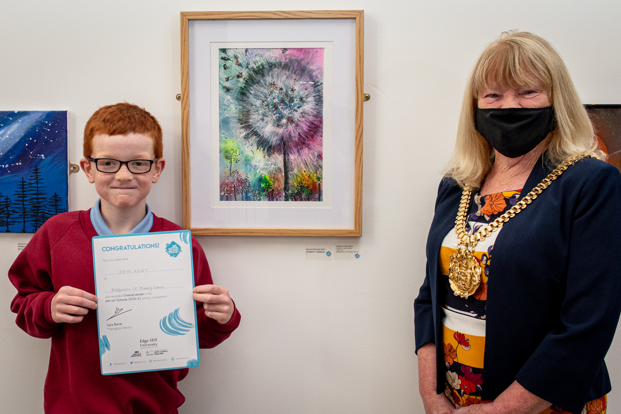dot-art schools little boy holding certifcate in front of artwork with lord mayor of liverpool to the right