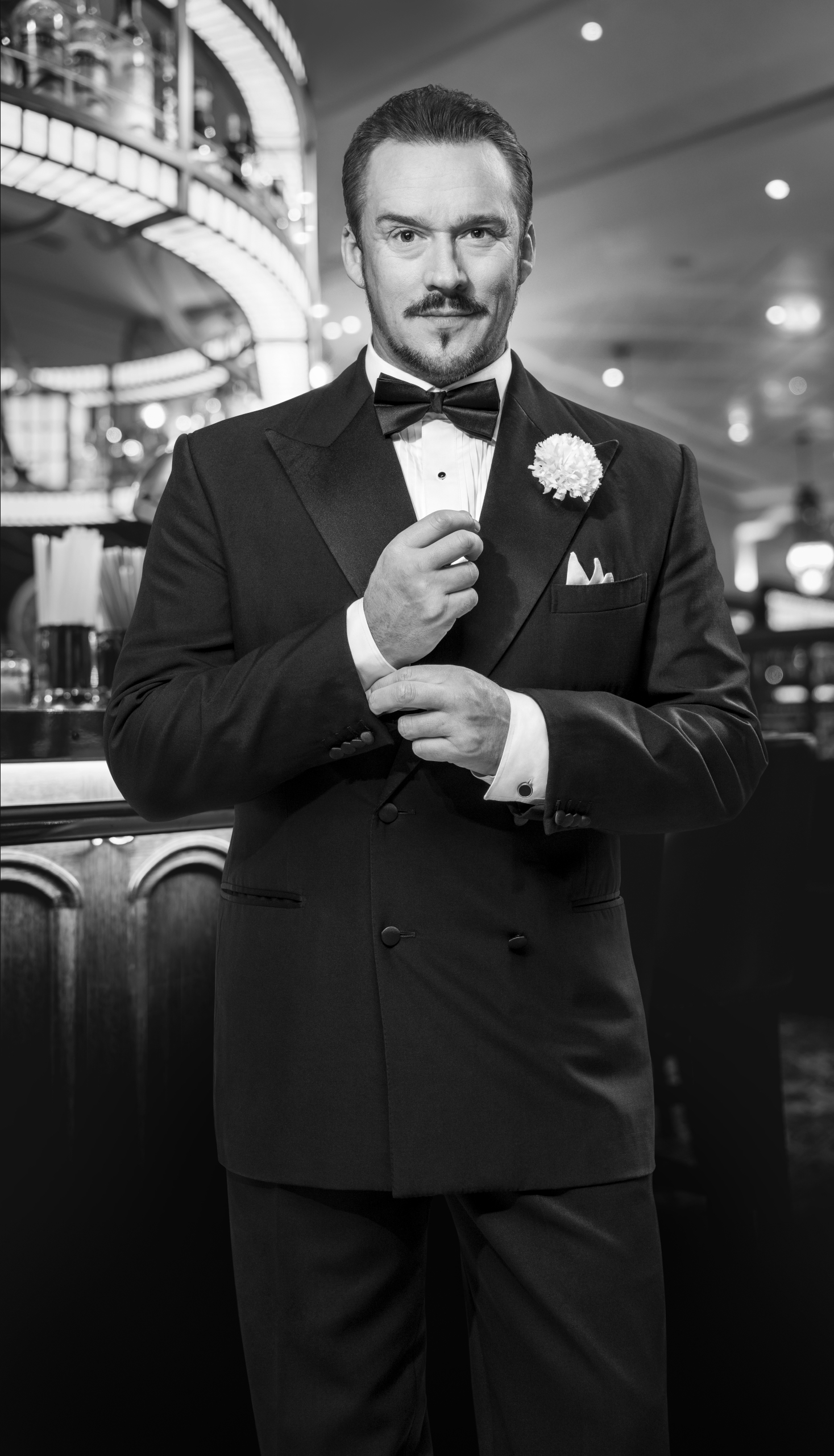 russell watson in tuxedo in a black and white photo