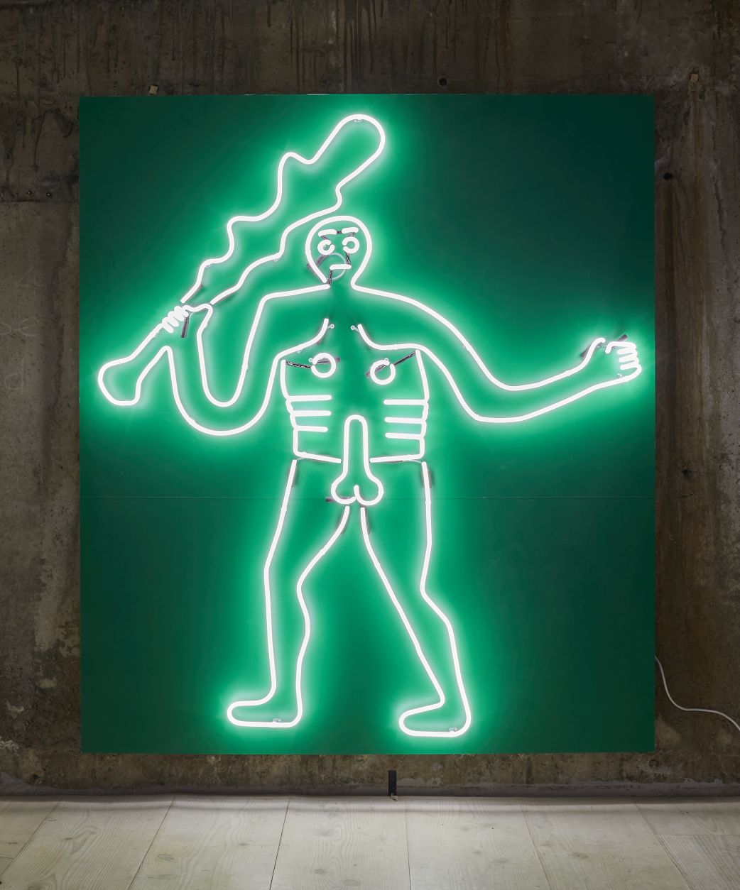 neon green outline of a male holding a stick as part of radical landscapes exhibit