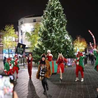 people dressed as elves performing in liverpool city centre