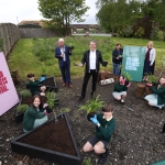 Metro Mayor Steve Rotheram at launch of The Good Business Festival Youth Summit in Knowsley Safari July 2021 standing in a plot of land surrounded by children and good business festival signage