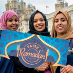 three ladies holding a sign hat says taste ramadan