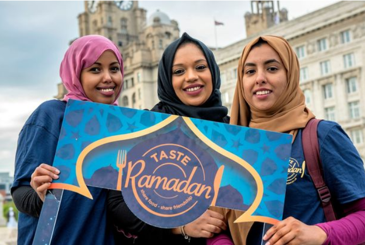 three ladies holding a sign hat says taste ramadan