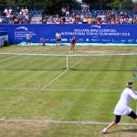 liverpool international tennis features two people playing on the green