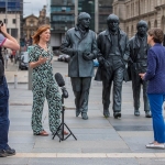 culture liverpool director claire mccolgan being interviewed on film in front of beatles statues