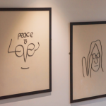 two framed images of john lennon and one says peace and love