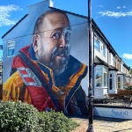 mural on the side of a house in a row of houses of an RNIB man