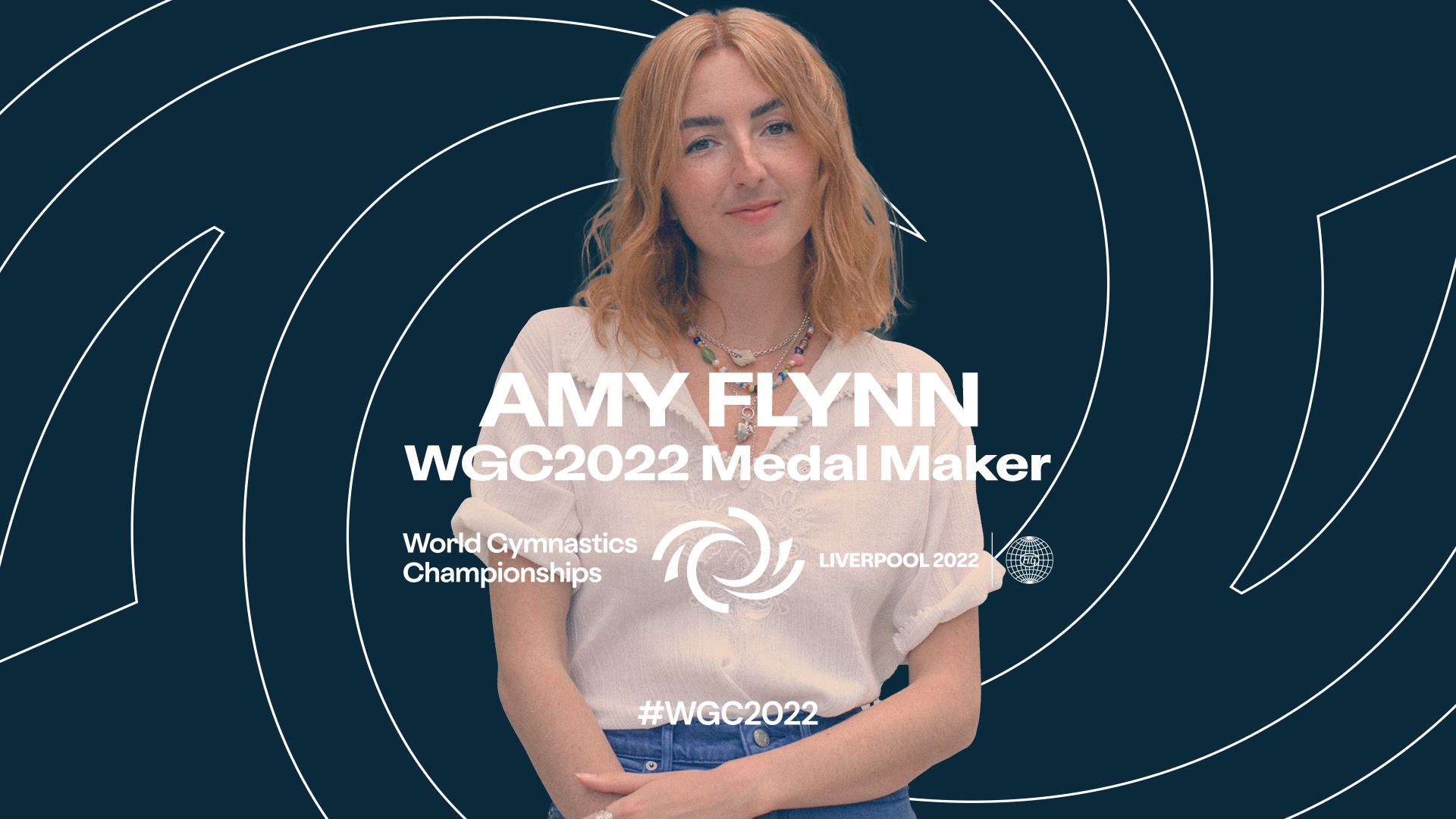 Amy Flynn against a blue backdrop with white swirls, white text says Amy Flynn WGC2022 Medal Maker for gymnastics championships