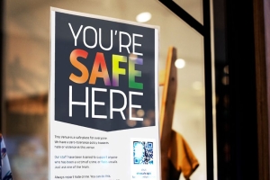 Poster in shop window that says youre safe here 