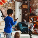 children playing inside the storybarn with bubbles