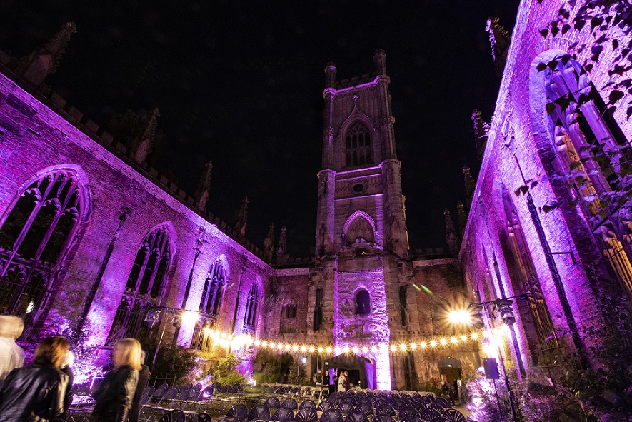inside bombed out church liverpool with purple lighting for theatre festival