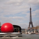 redball on back of a boat in front of the eiffel tower