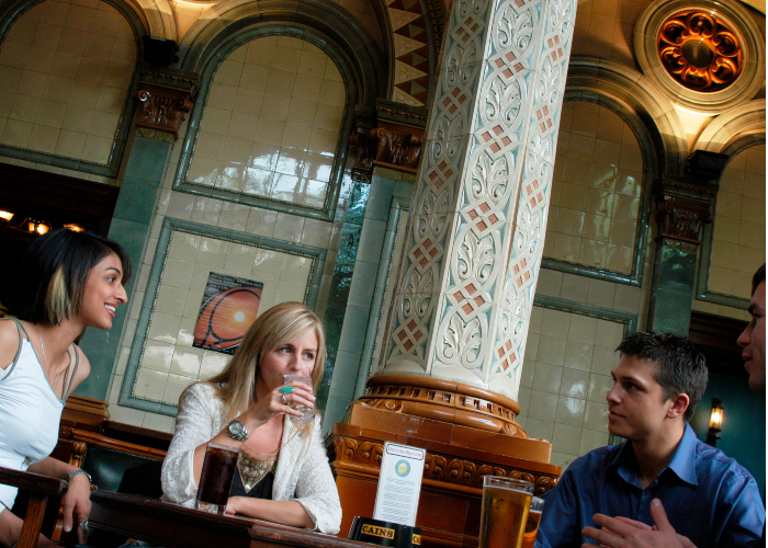 Four people enjoying a drink in one of Liverpool's pubs