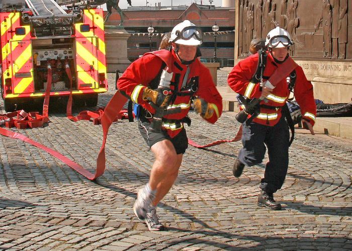 Two firemen compete during the World Firefighter Games 2008