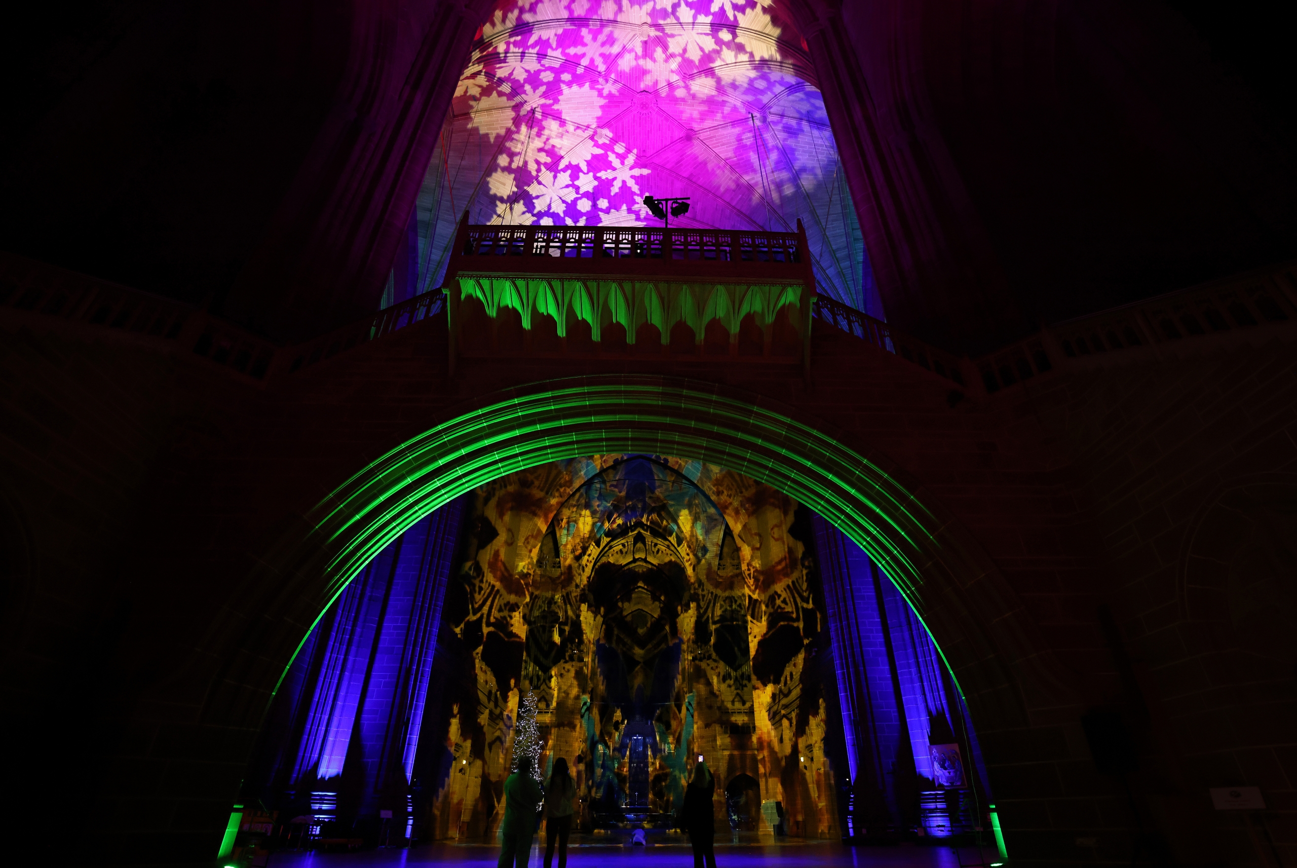blue, green and pink light show inside liverpool cathedral