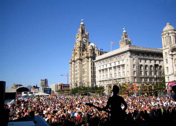 Crowds watching performers on stage at Mathew Street Music Festival on the Pier Head