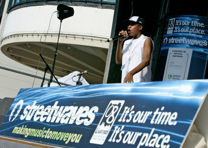 young man performing on stage in Liverpool