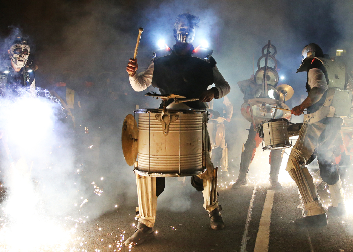 drummers illuminated with light and sparklers during bonfire night's River of Light in 2016