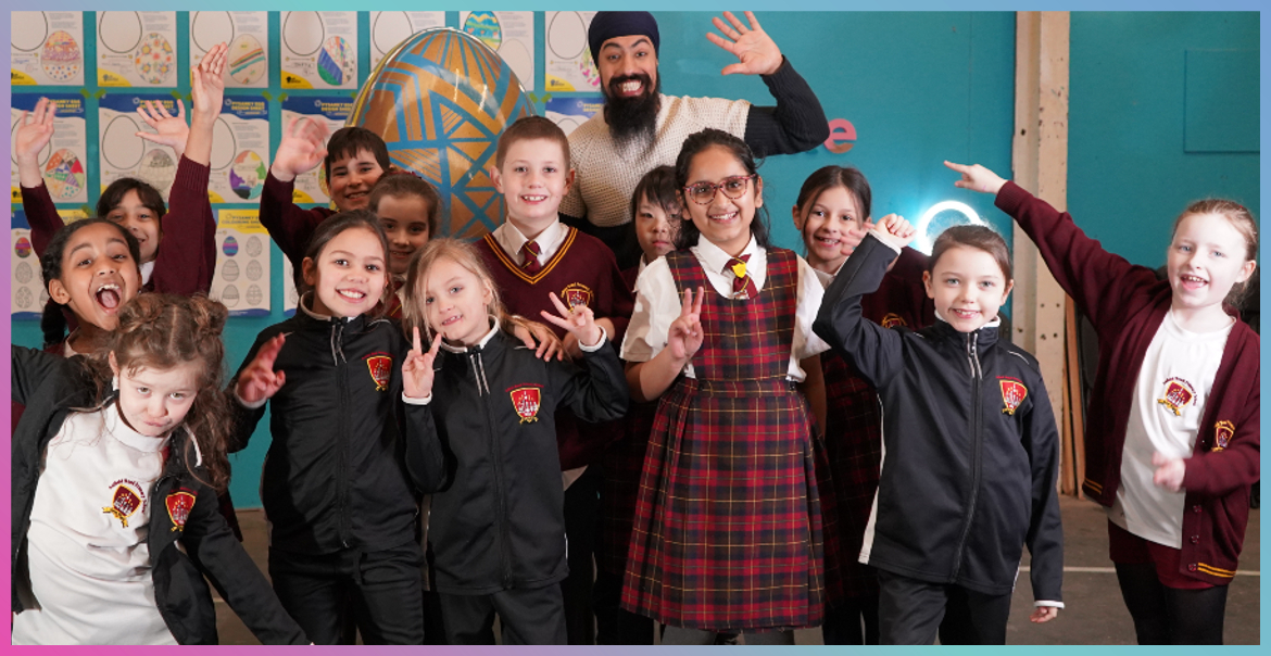 MrASingh surrounded by primary school children proudly showcasing their pysanka egg sculpture