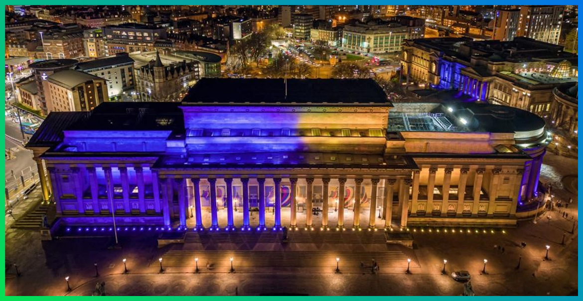 picture of St Georges Hall in Liverpool lit up in the colours of the Ukrainian flag