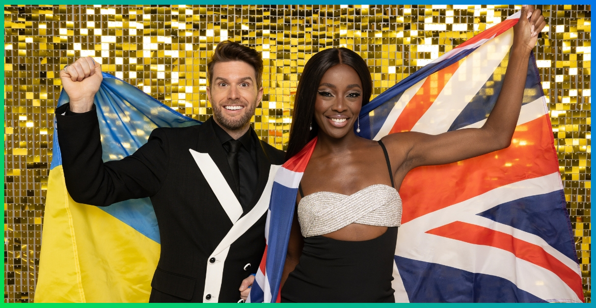 Joel Dommett holding up a Ukrainian flag and AJ Odudu holding up a Great Britain glag in front of a gold glittery background.
