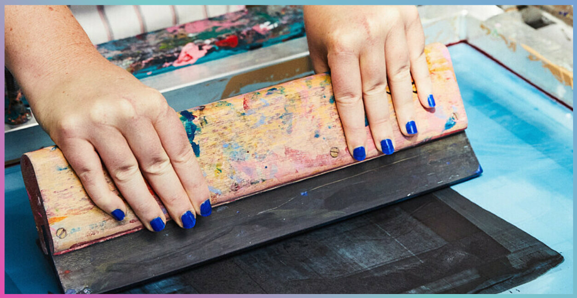 A person wearing blue nail varnish screen printing.