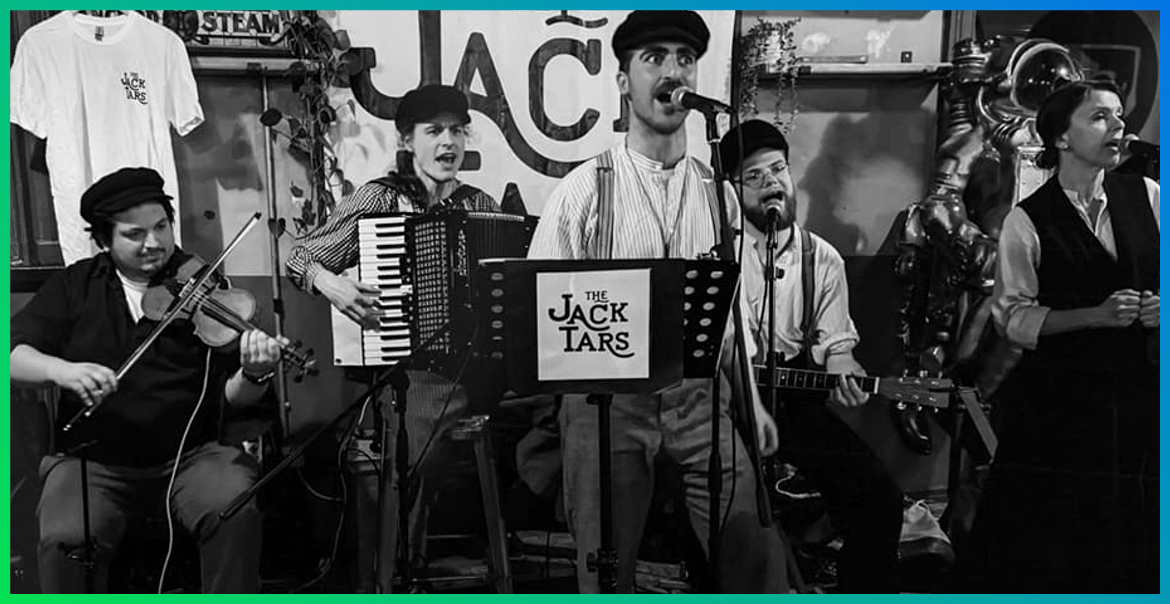 musicians singing and playing the accordion and fiddle as part of the Jack Tars band
