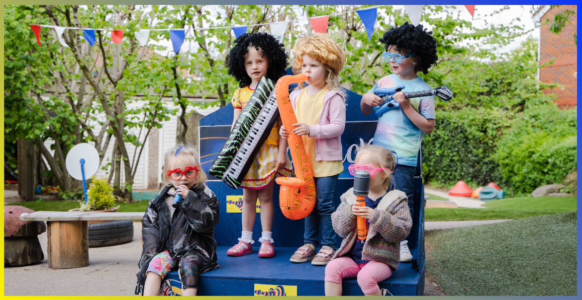 Five pre-schoolers are dressed in wigs and have inflatable instruments as they perform a Eurovision-themed performance.