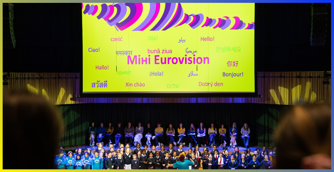 The Mihi Eurovision finale taking place on stage at the Tung Auditorium with a large choir of primary school children.