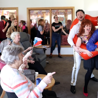 A Eurovision-themed performance taking place in a care home lounge for all of the residents.