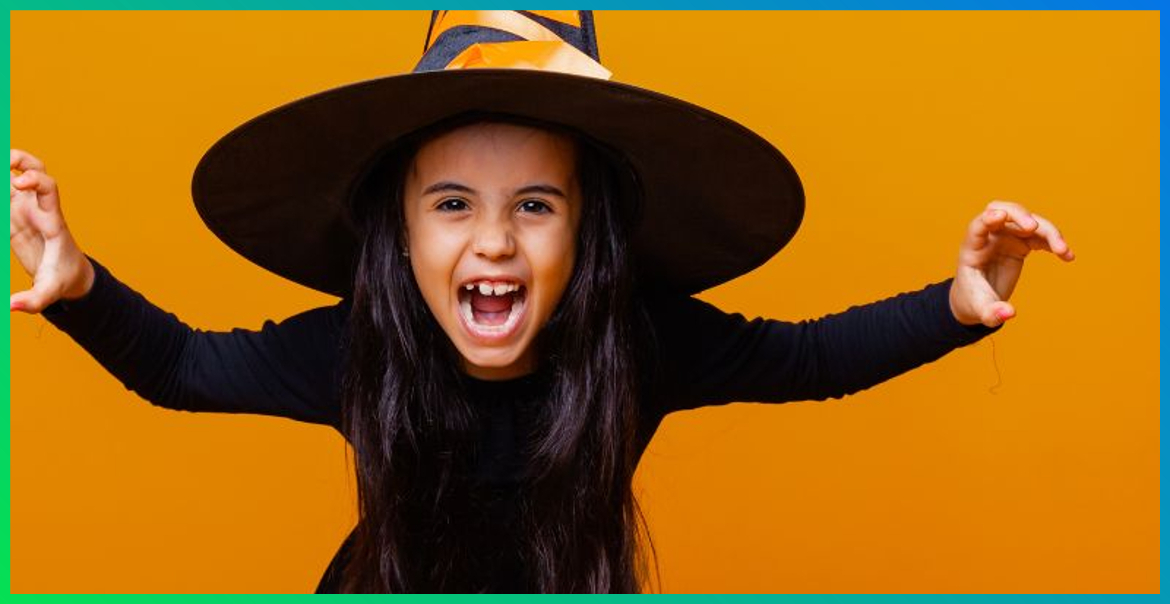 A young child wearing witches costume for Halloween.