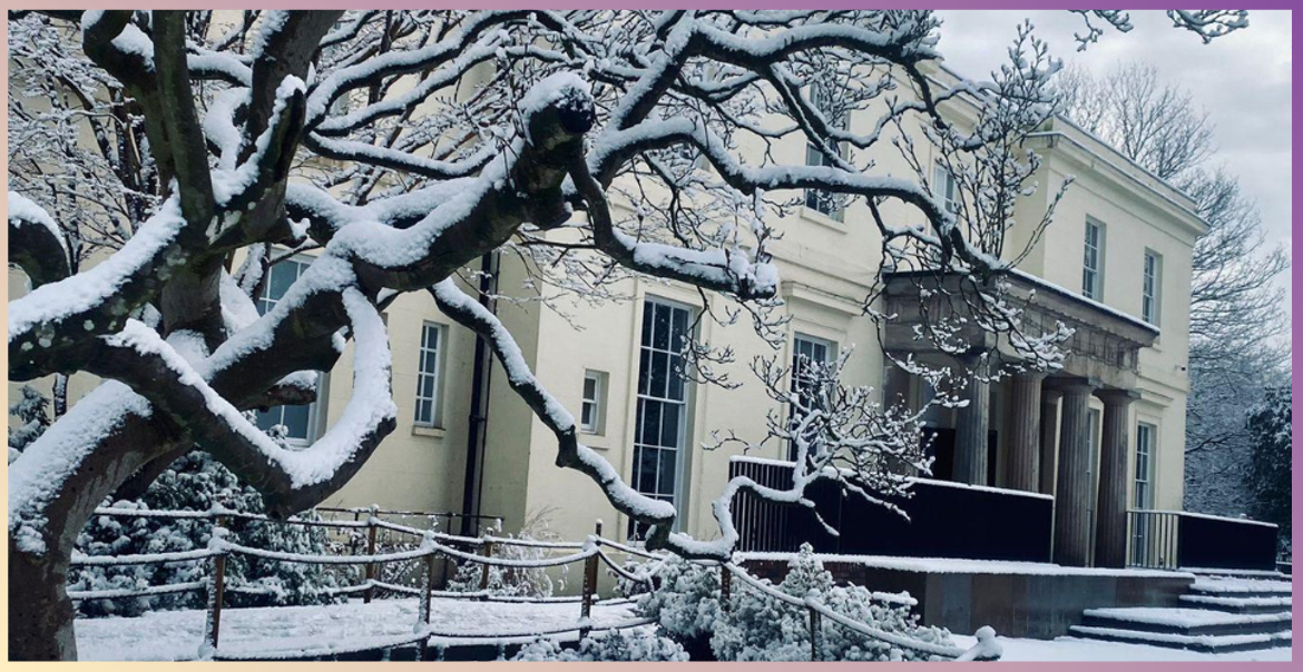 The Mansion at Calderstones Park covered in snow during winter time.