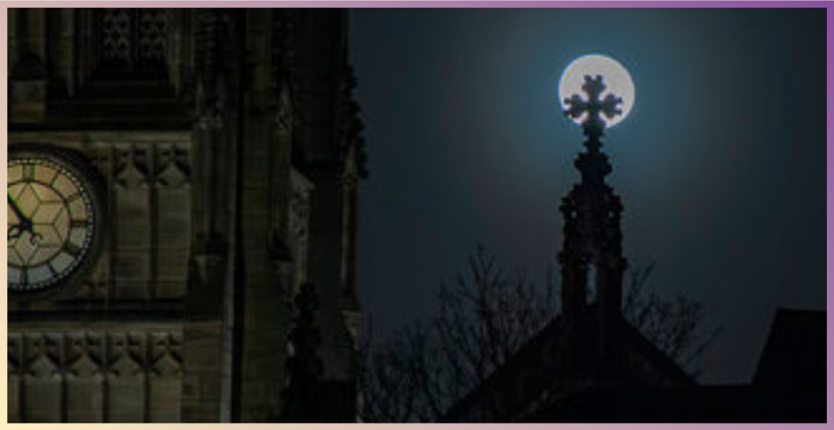 spooky halloween picture of a clock face, church spire and full moon