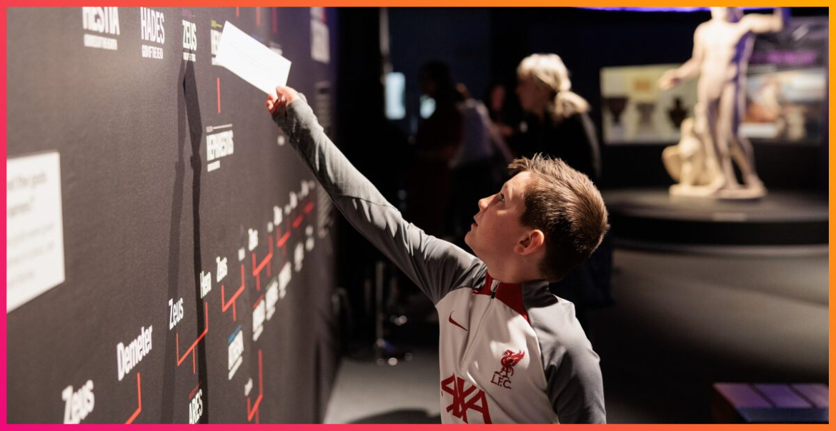 A young boy interacting with a museum exhibit.