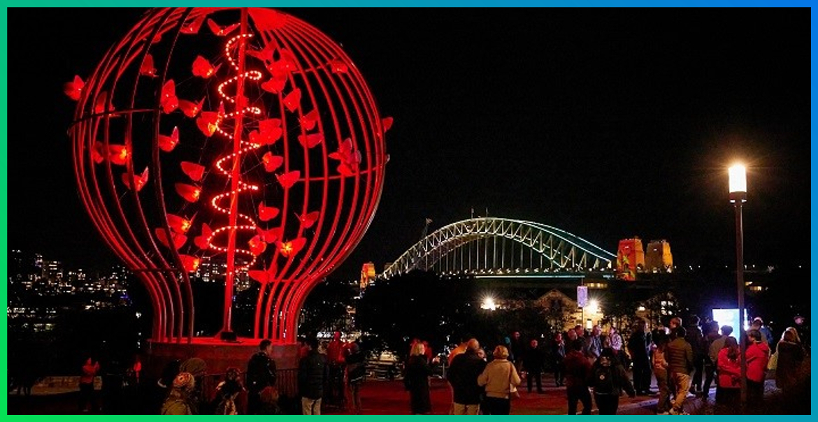 picture of a red light installation shaped like a bulb containing butterflies