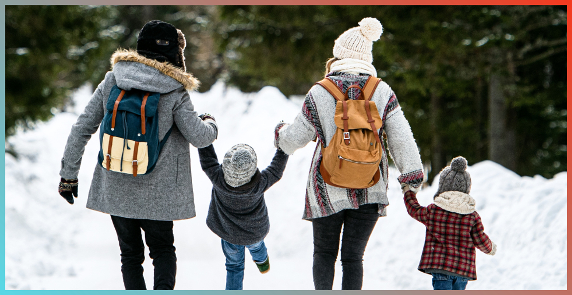 A family of four walking in the snow.