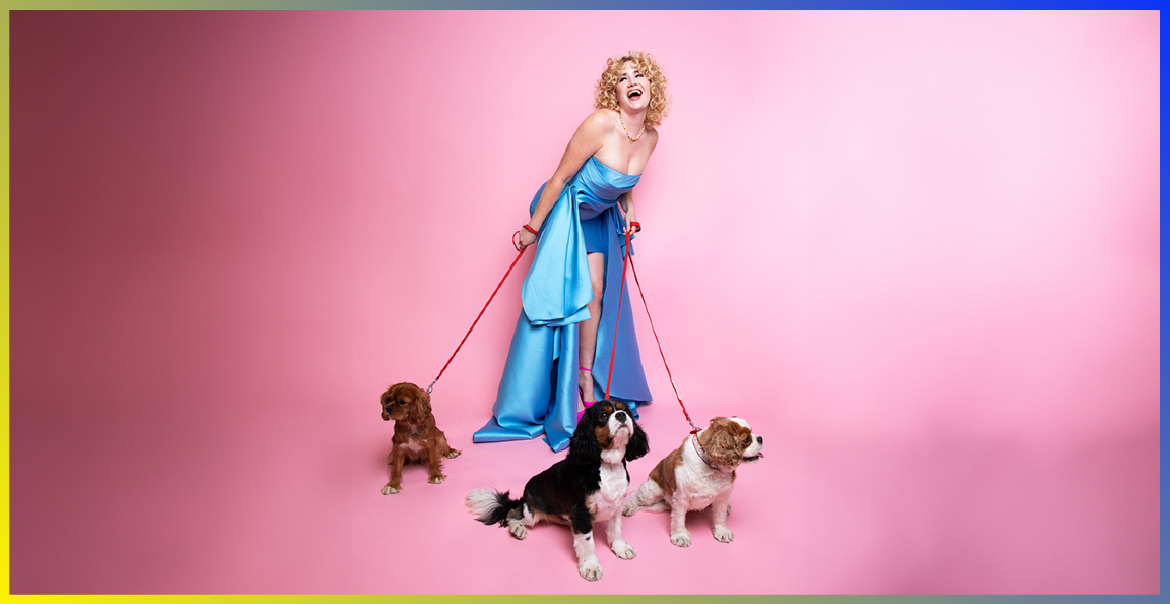 Grace Campbell walking three dogs against a pink background.