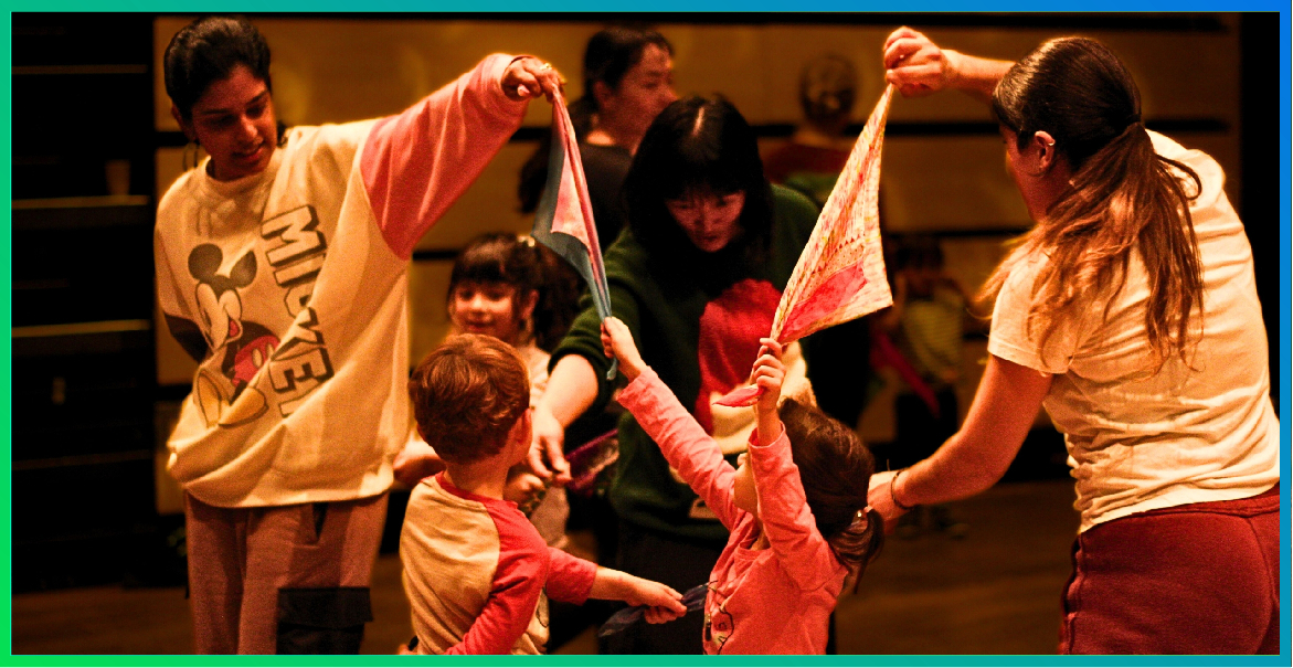 Adults and children dancing as part of a dance class.