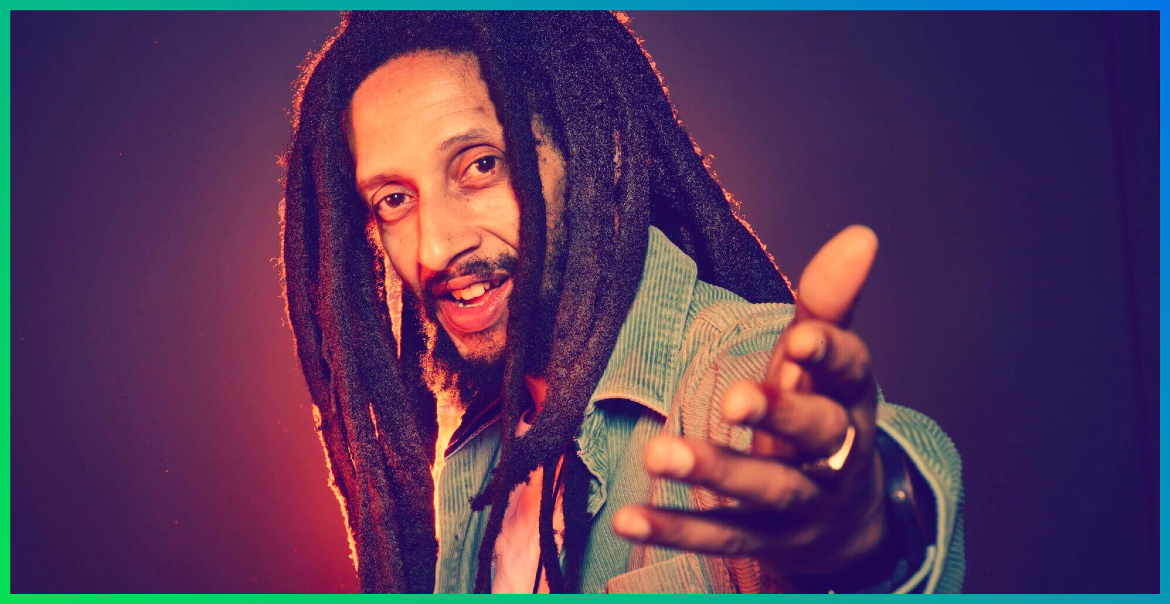 An image of Julian Marley holding out his hand.